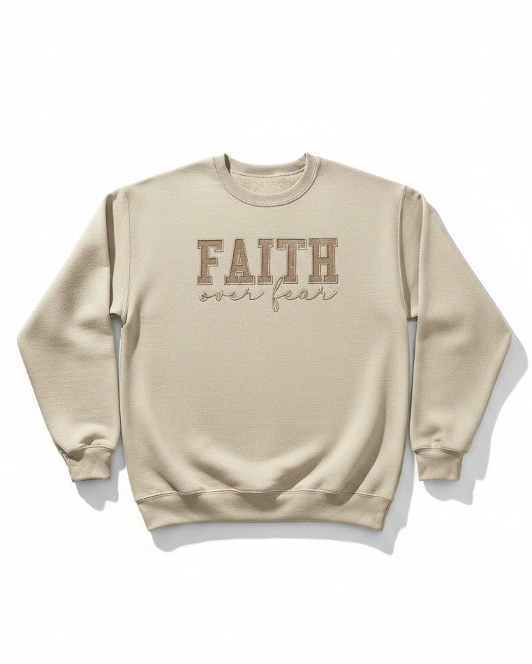 Beige sweatshirt with 'FAITH over fear' text on a white background